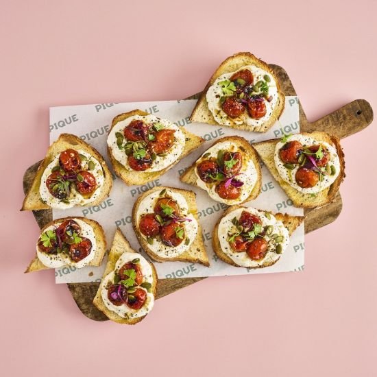 Whipped herby soft cheese on sourdough with dukkah & slow roast tomatoes