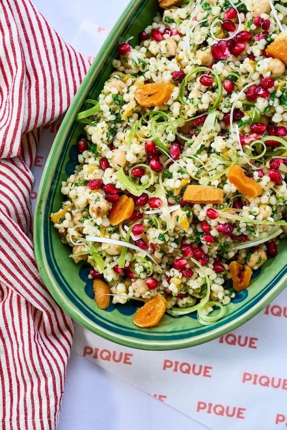Giant cous cous with chickpeas, pickled apricots, spring onion, herbs & pomegranate